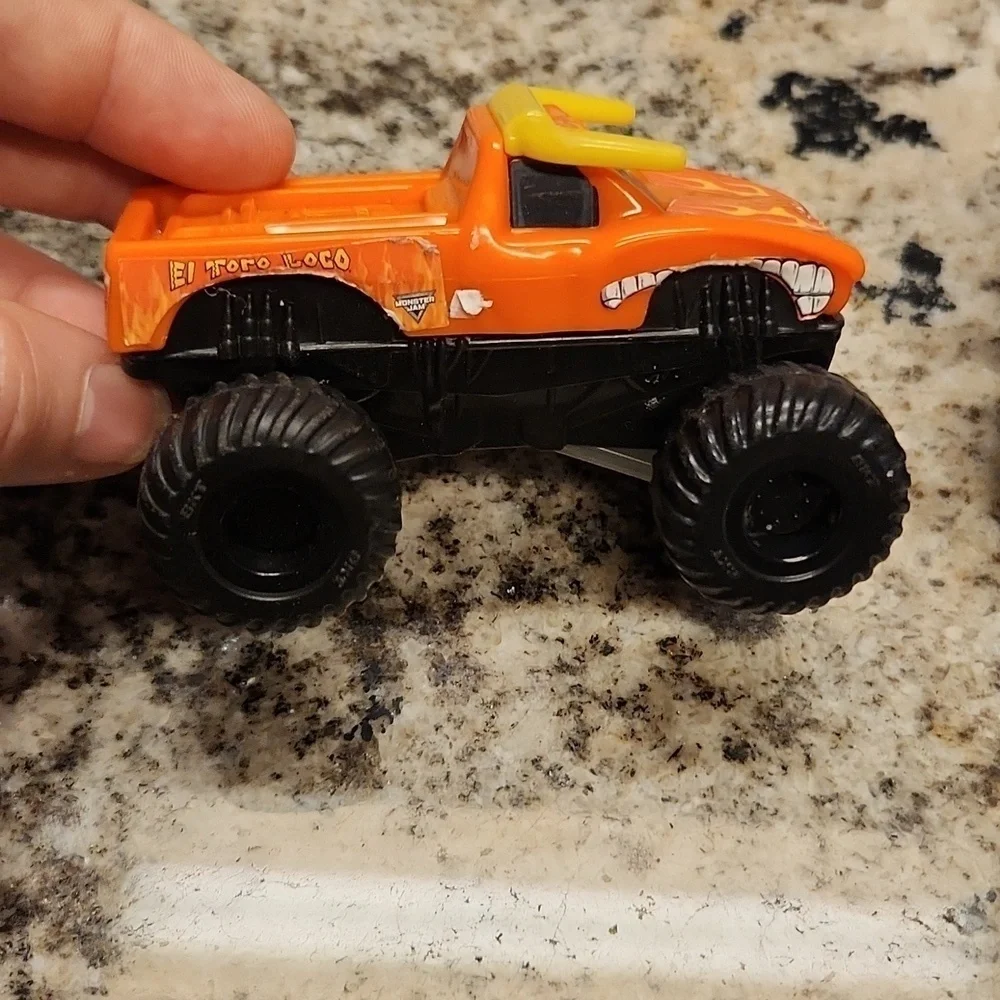 Monster jam plastic Rev up trucks has paper stickers ripping 2 cars